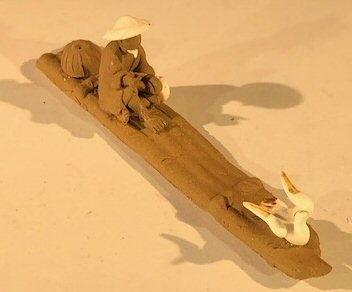 Miniature Ceramic Figurine Mud Man Riding On Raft With Ducks 1"